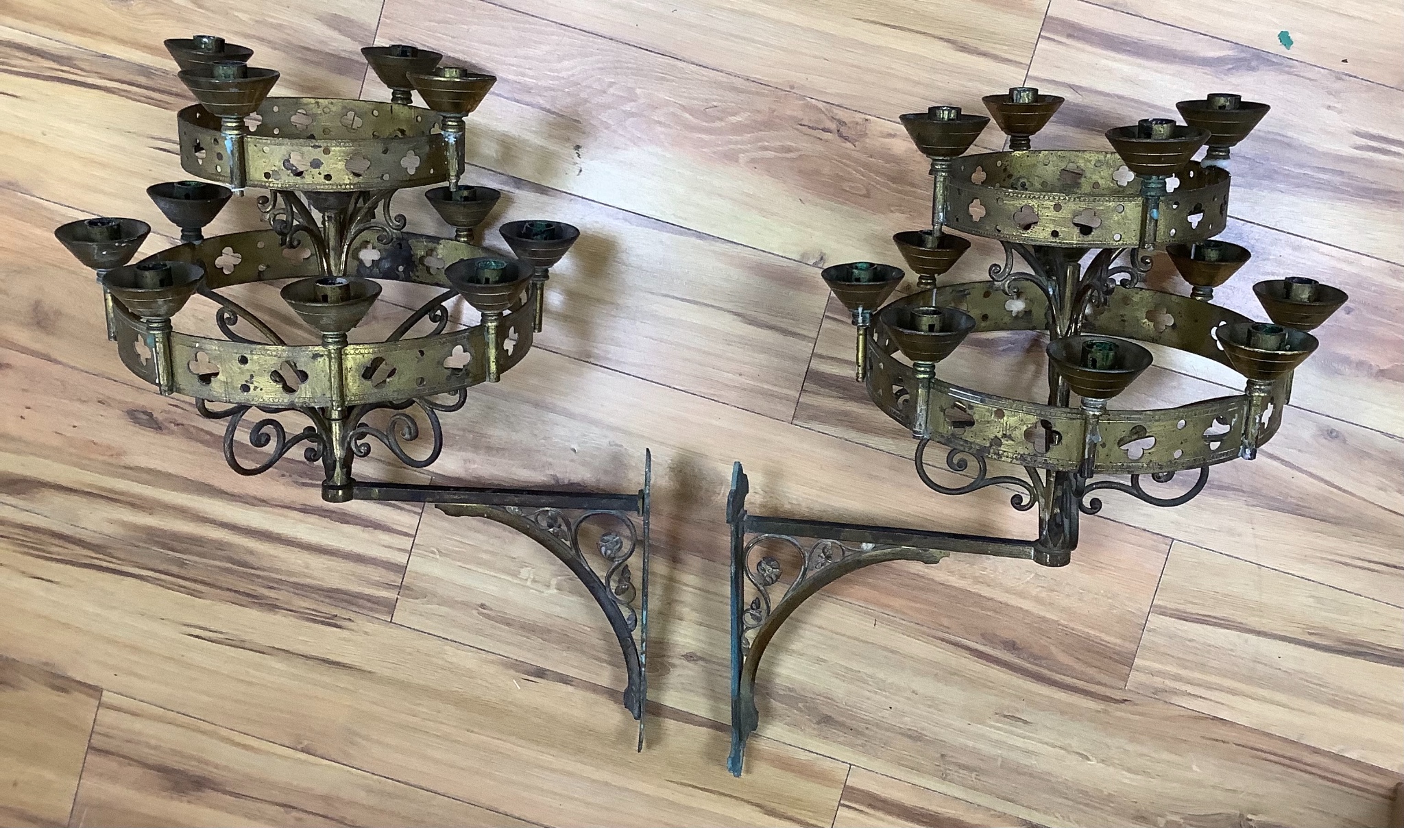 A pair of Gothic revival brass two tier wall candelabra, projection 50cm, 68 cm high